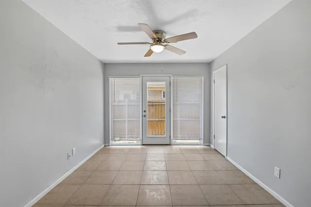a view of an empty room with a ceiling fan