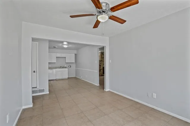 an empty room with closet and windows