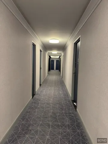 a view of hallway with wooden floor