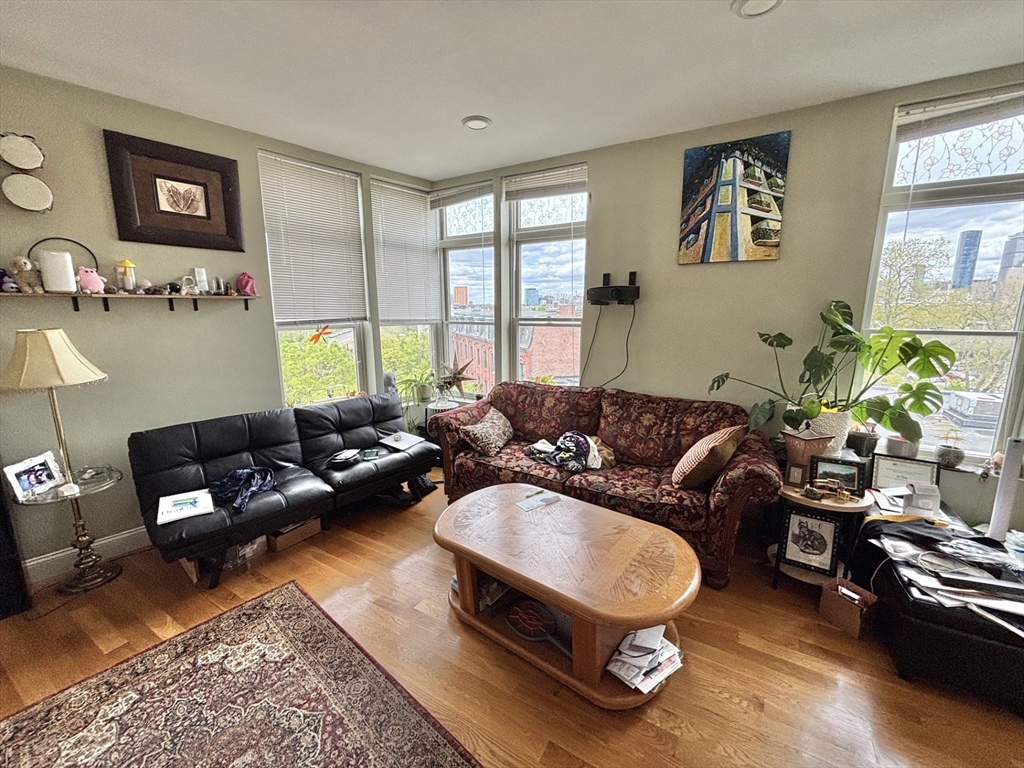 10 Roxbury Street, Unit 10 Boston, MA 02119 - Photo 7 of 8 a living room with furniture rug and window