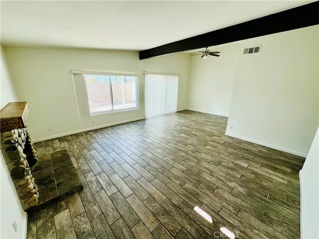 a kitchen with a stove cabinets and a wooden floor
