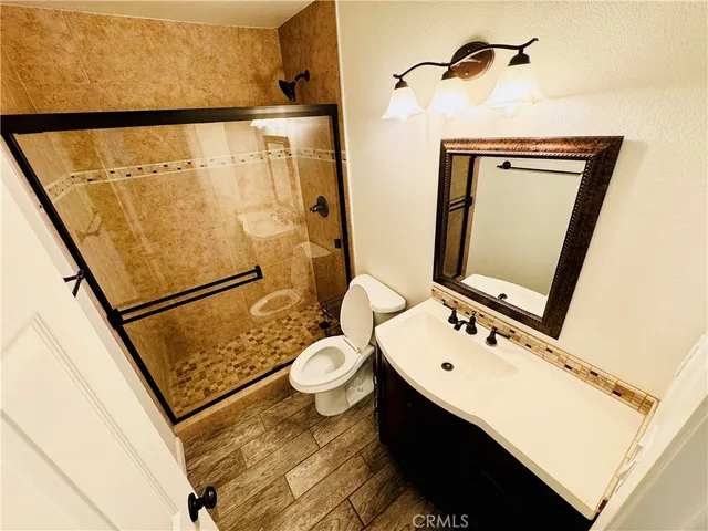 a bathroom with a sink mirror vanity and toilet