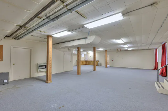 a front view of a house with a yard and shrubs