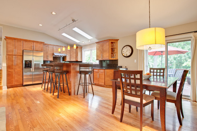 1212 Kenton Road Deerfield, IL 60015 - Photo 4 of 24 a kitchen with stainless steel appliances granite countertop a table chairs and a view of living room