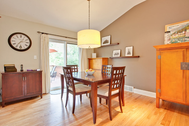 1212 Kenton Road Deerfield, IL 60015 - Photo 7 of 24 a dining room with wooden floor a glass table and chairs