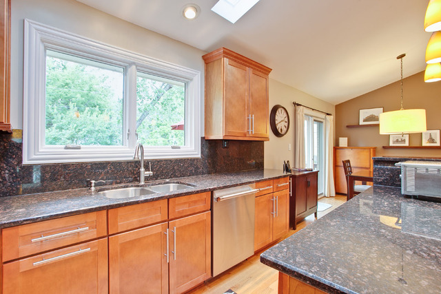 1212 Kenton Road Deerfield, IL 60015 - Photo 8 of 24 a kitchen with stainless steel appliances granite countertop sink stove and cabinets