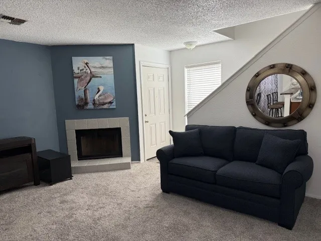 a living room with furniture and a fireplace