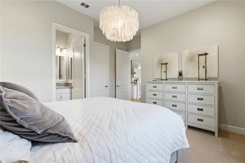 a bedroom with a bed a dresser and a window