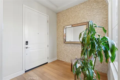 a dining room with furniture potted plants and wooden floor