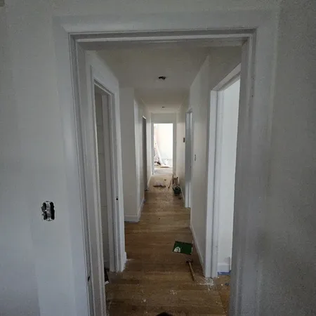 a view of a hallway with a wooden door