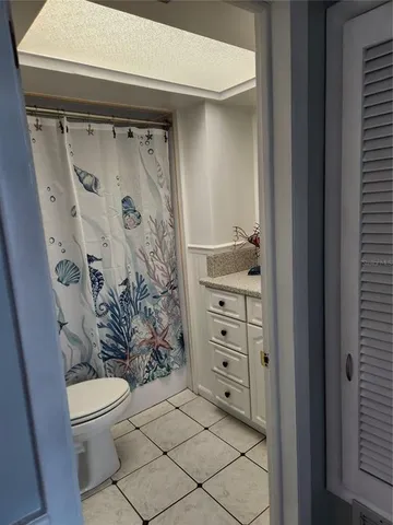 a kitchen with granite countertop a sink a stove and cabinets