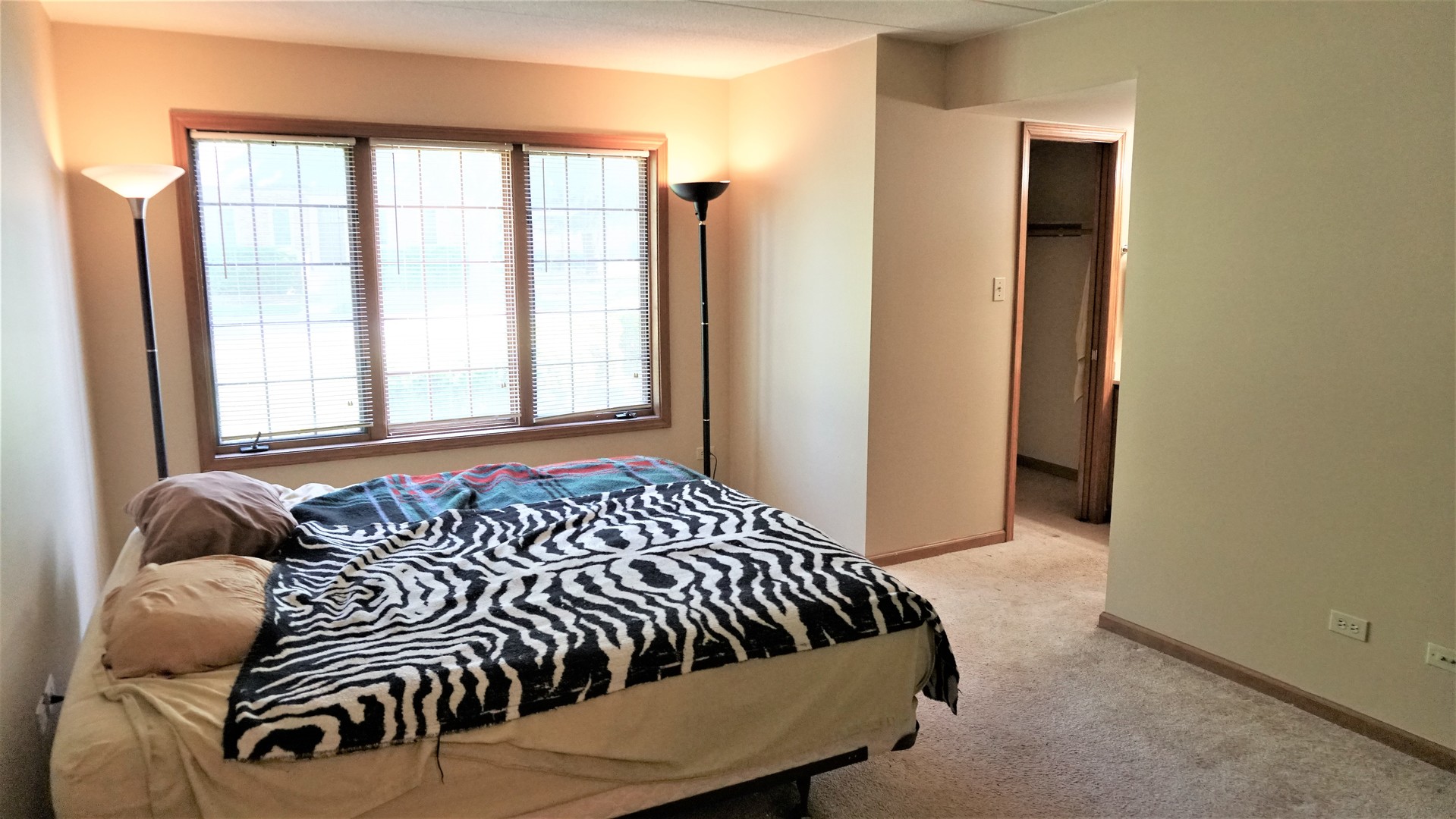 2161 Oak Road, Unit 1C Homewood, IL 60430 - Photo 11 of 17 a bed sitting in a bedroom next to a window