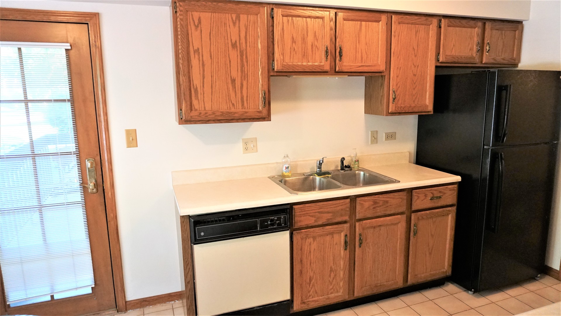 2161 Oak Road, Unit 1C Homewood, IL 60430 - Photo 9 of 17 a kitchen with a sink cabinets and a refrigerator