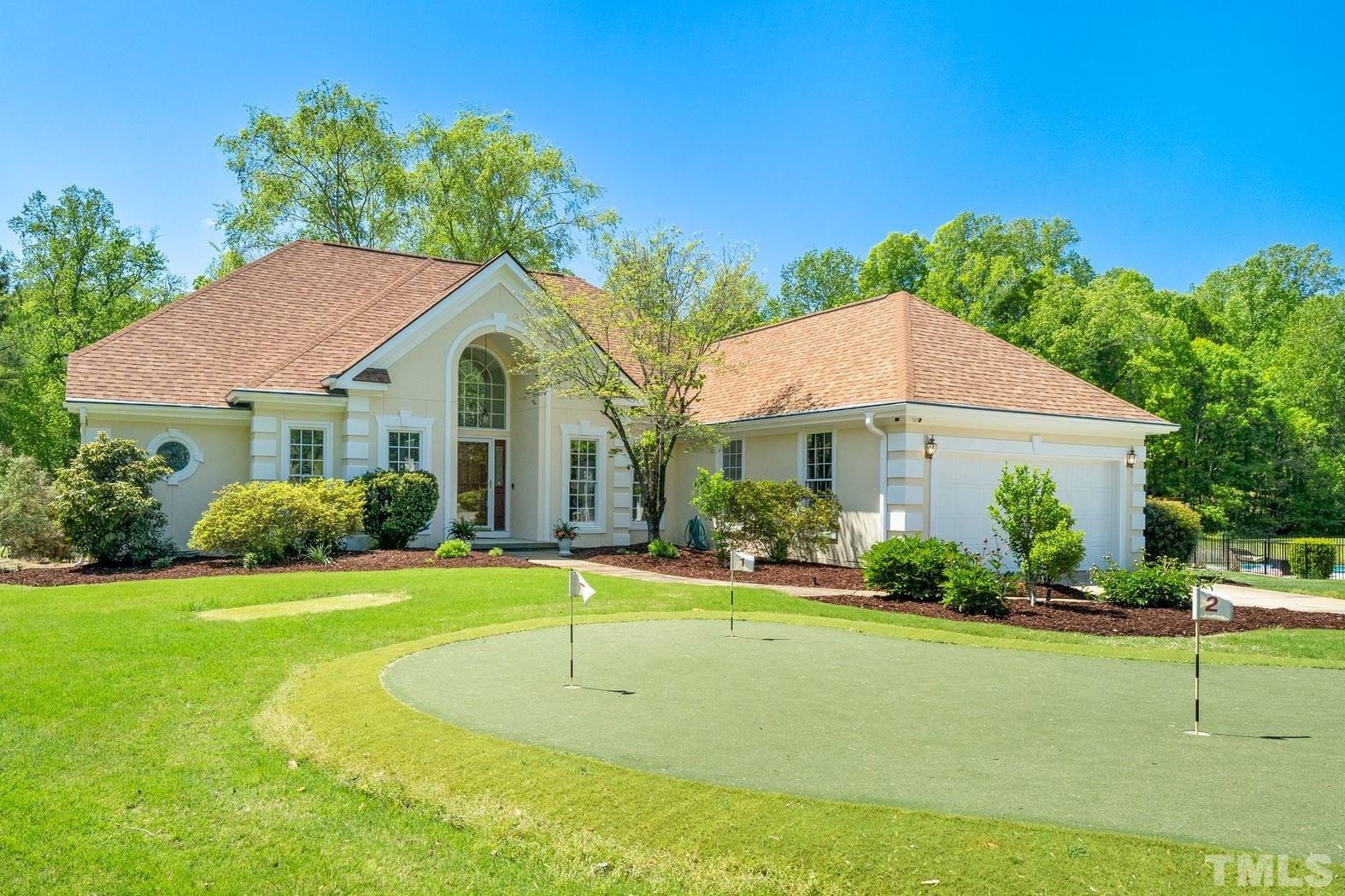 7801 Hogan Drive Wake Forest, NC 27587 - Photo 1 of 51 a view of a white house with a yard table and chairs