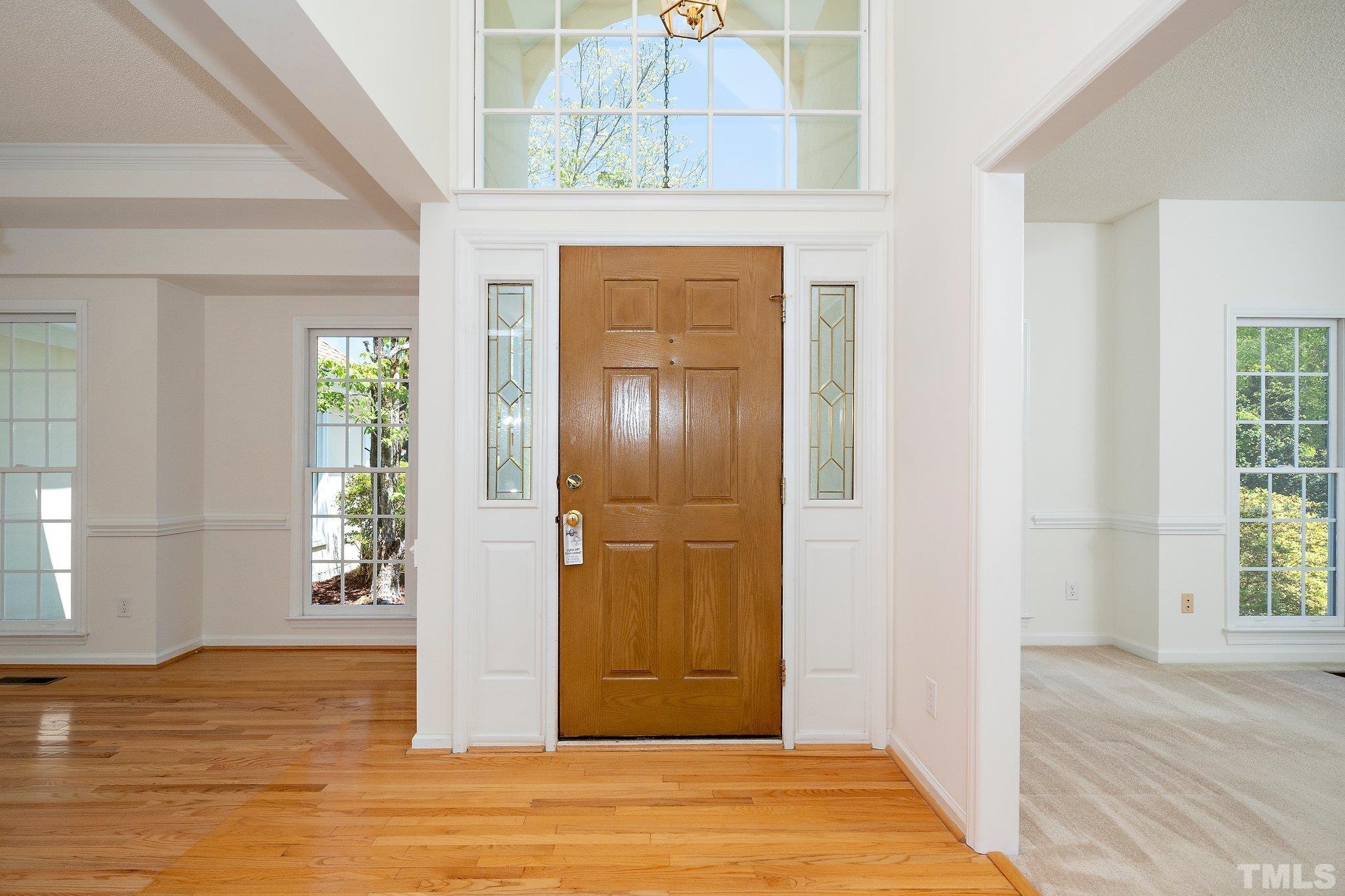 7801 Hogan Drive Wake Forest, NC 27587 - Photo 12 of 51 a view of a hallway with wooden floor and front door