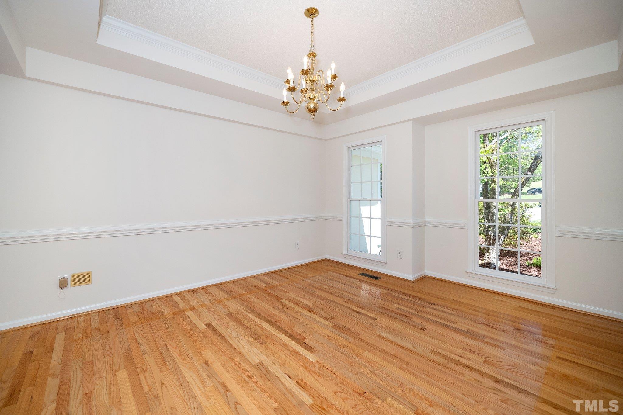 7801 Hogan Drive Wake Forest, NC 27587 - Photo 14 of 51 a view of an empty room with a window and wooden floor