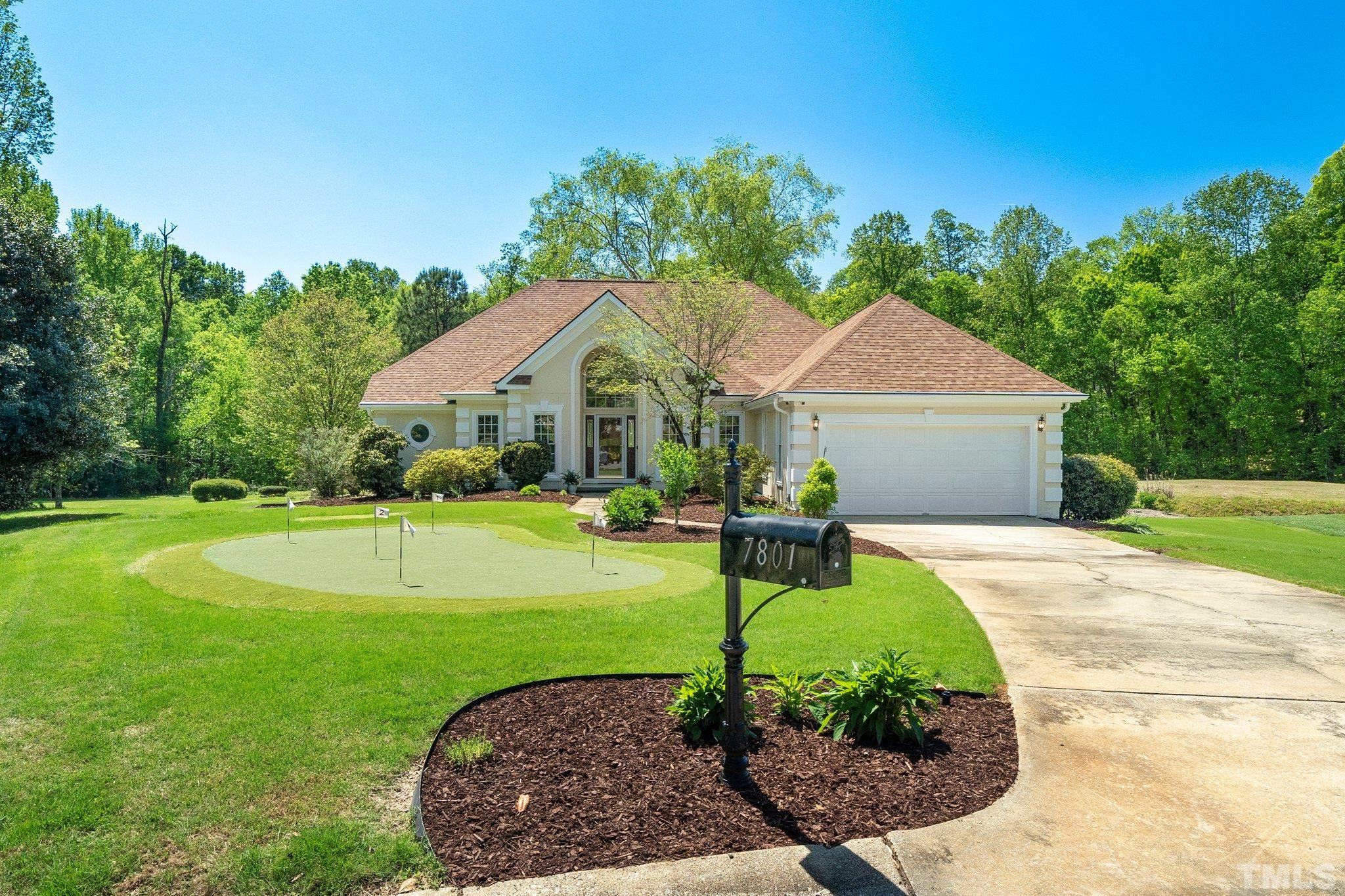 7801 Hogan Drive Wake Forest, NC 27587 - Photo 2 of 51 a front view of a house with garden