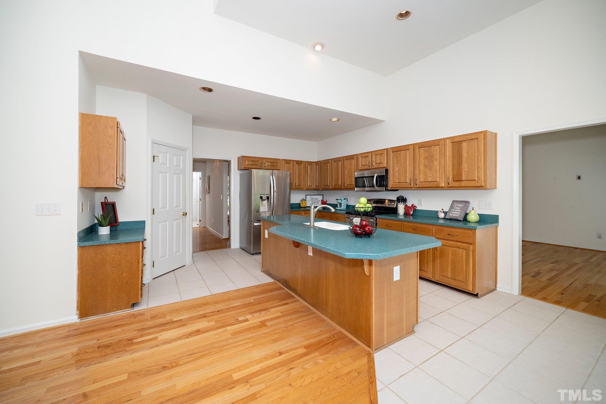 7801 Hogan Drive Wake Forest, NC 27587 - Photo 22 of 51 a kitchen with stainless steel appliances granite countertop a stove top oven