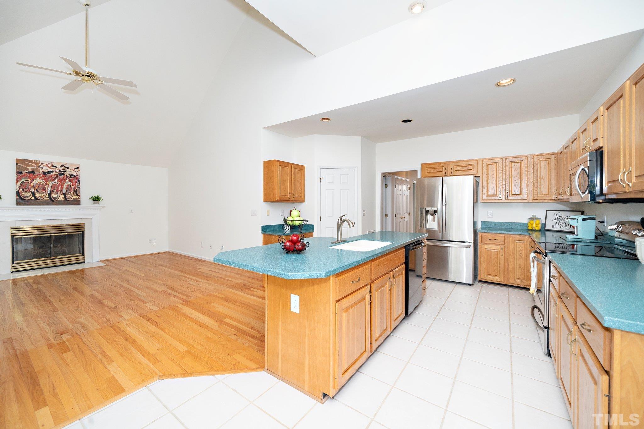 7801 Hogan Drive Wake Forest, NC 27587 - Photo 23 of 51 a kitchen with stainless steel appliances kitchen island granite countertop a sink and cabinets