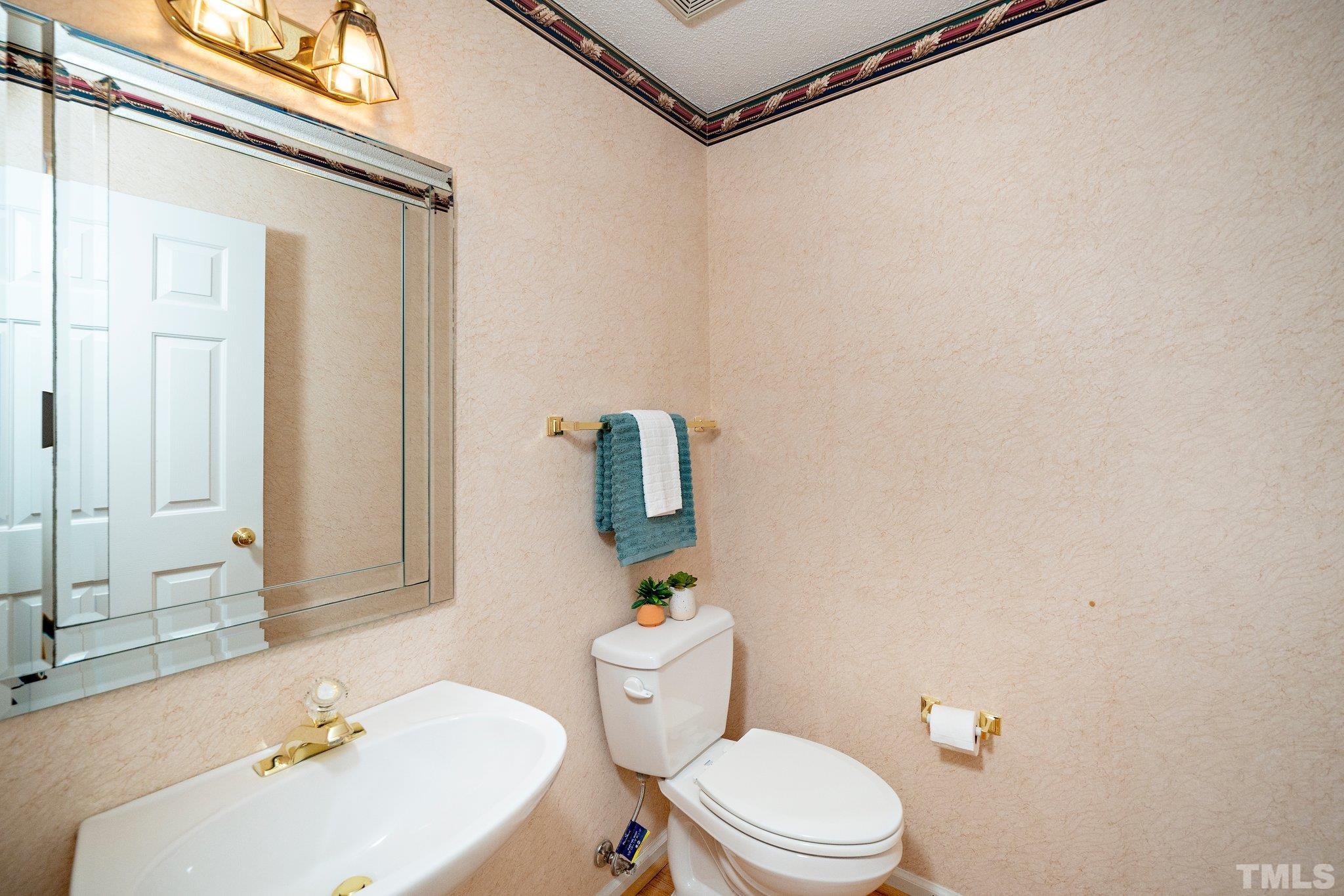 7801 Hogan Drive Wake Forest, NC 27587 - Photo 30 of 51 a bathroom with a sink a toilet and shower