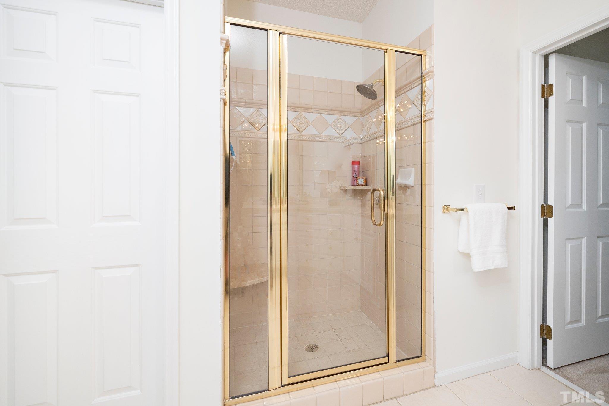7801 Hogan Drive Wake Forest, NC 27587 - Photo 35 of 51 a bathroom with a glass shower door