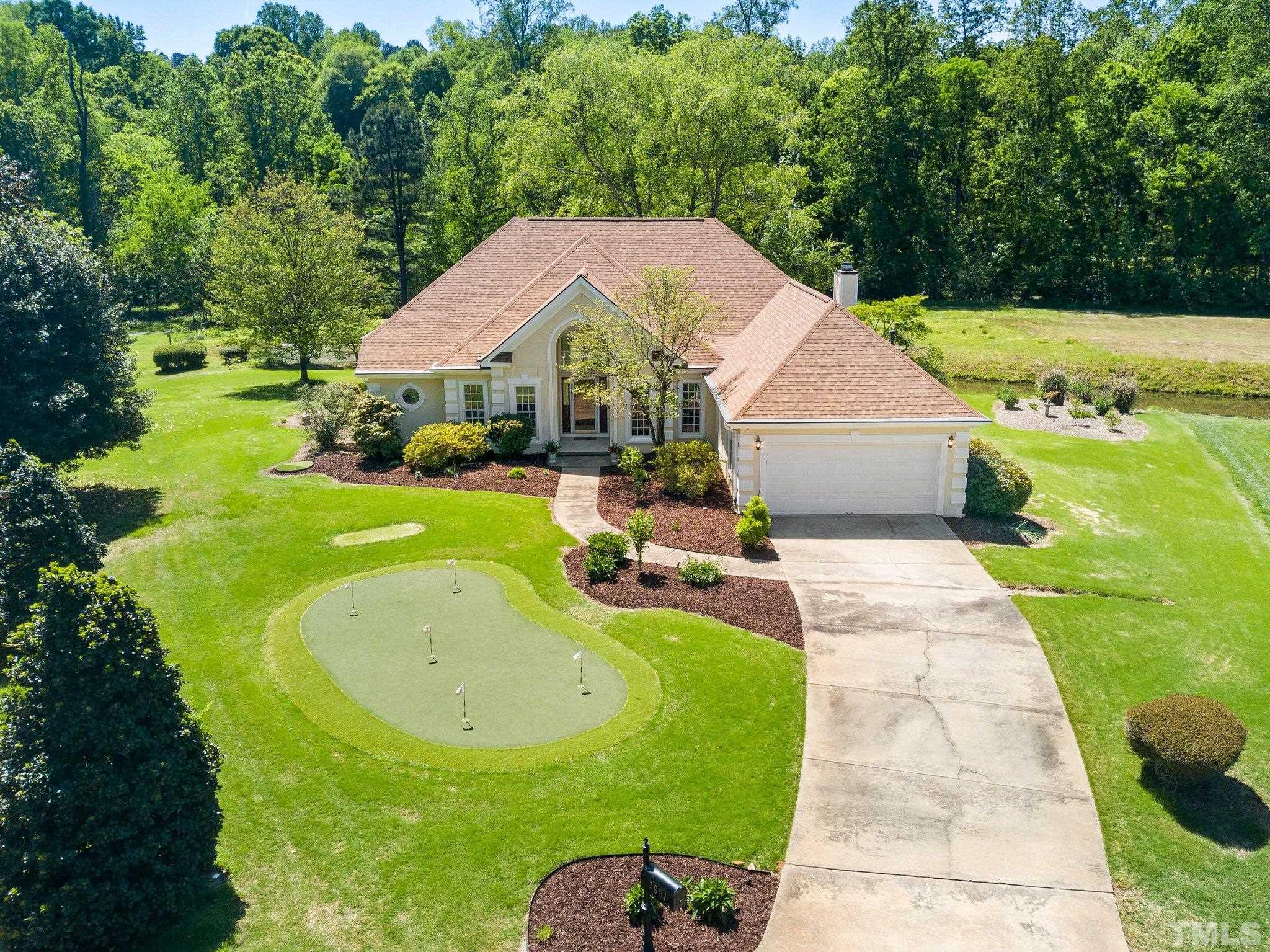 7801 Hogan Drive Wake Forest, NC 27587 - Photo 4 of 51 a view of a swimming pool with a garden