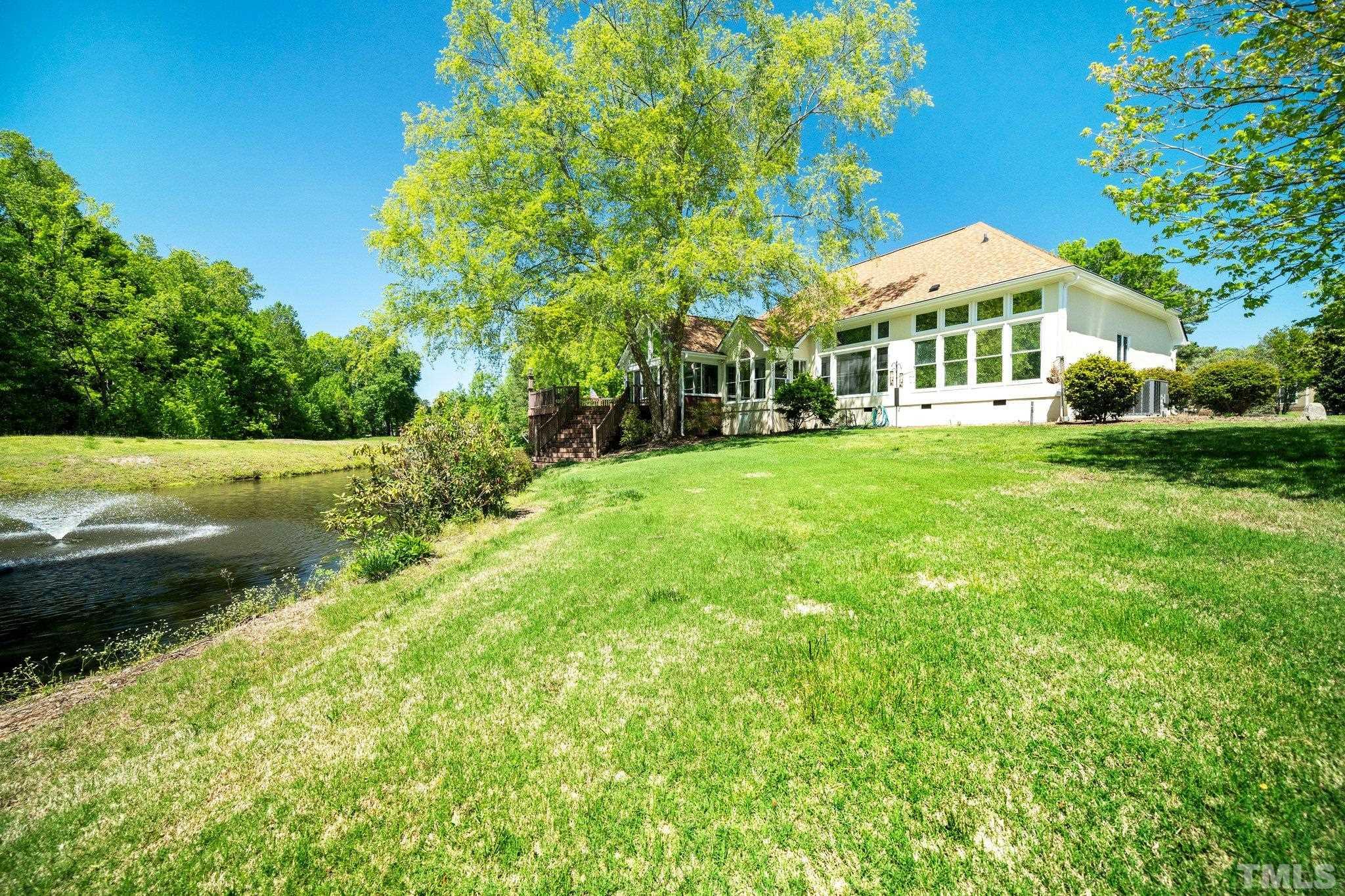 7801 Hogan Drive Wake Forest, NC 27587 - Photo 44 of 51 a view of a house with a big yard and large trees