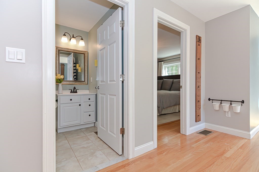 9 Broadway Stoneham, MA 02180 - Photo 17 of 42 wooden floor with white cabinets