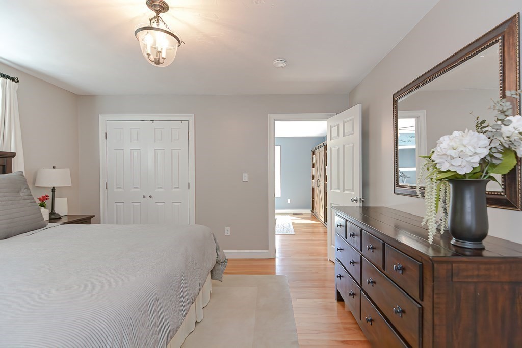 9 Broadway Stoneham, MA 02180 - Photo 23 of 42 a spacious en suite bathroom with a granite countertop double vanity sink and a mirror