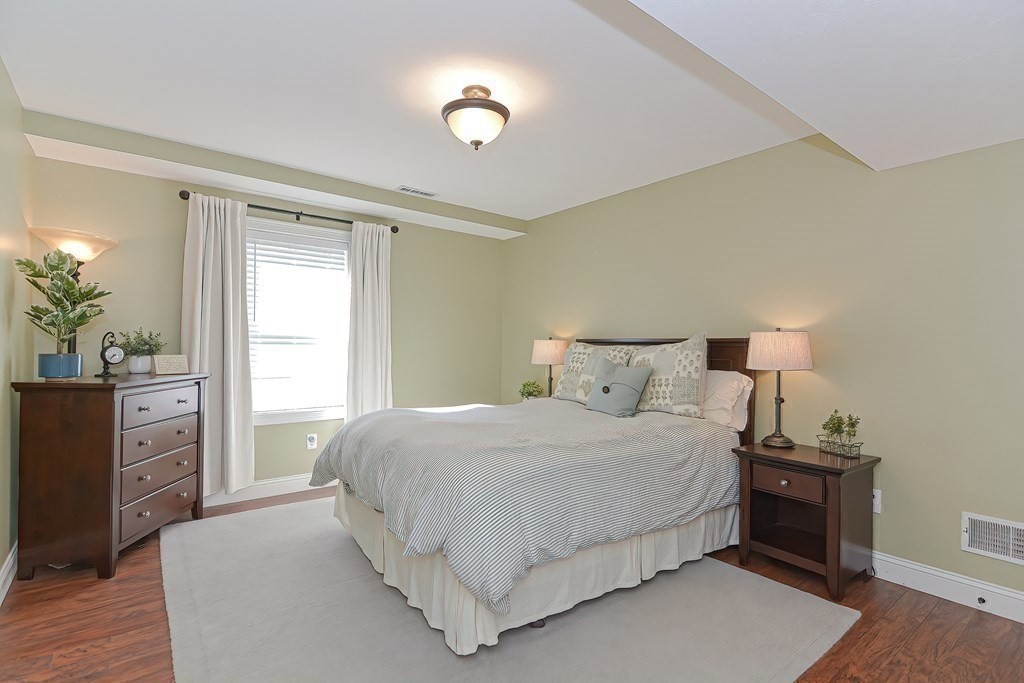 9 Broadway Stoneham, MA 02180 - Photo 37 of 42 a bedroom with a bed and a dresser