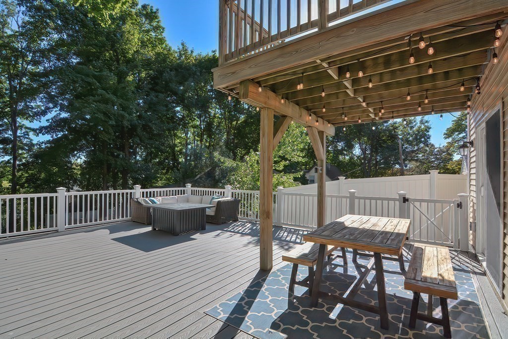 9 Broadway Stoneham, MA 02180 - Photo 38 of 42 a view of a patio with table and chairs and wooden floor