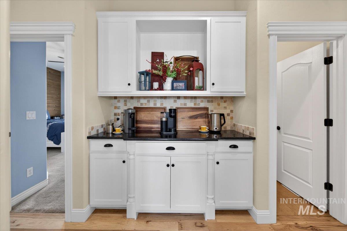 414 East Shafer View Drive Meridian, ID 83642 - Photo 15 of 50 Designated COFFEE BAR or Built-In Buffet Area has Granite Slab countertops, mosaic tile backsplash, Built-in White painted cabinetry w/soft close cabinets & Pull out cabinet drawers.