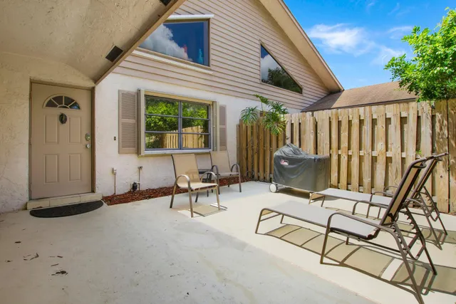 a building outdoor space with patio furniture and potted plants