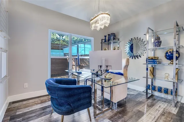 a living room with furniture a chandelier and a window