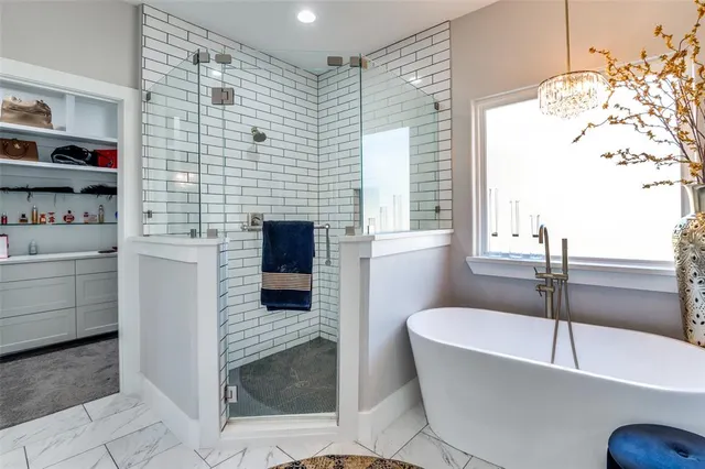a bathroom with a bathtub and a shower