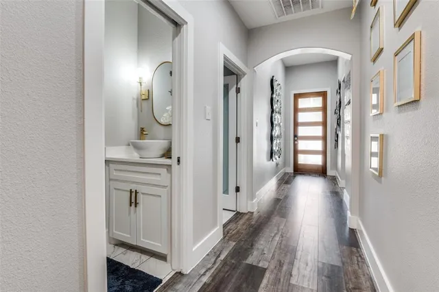 a view of a hallway with wooden floor