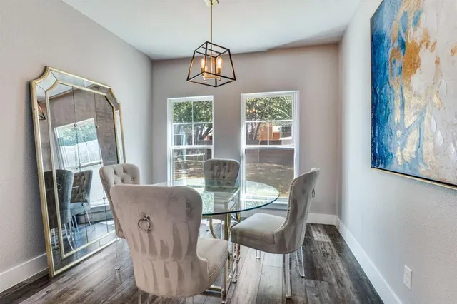 a view of a dining room with furniture wooden floor and a chandelier