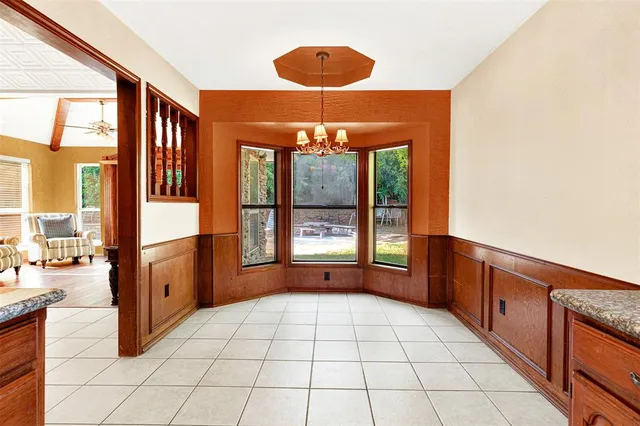 a large kitchen with a large window and stainless steel appliances