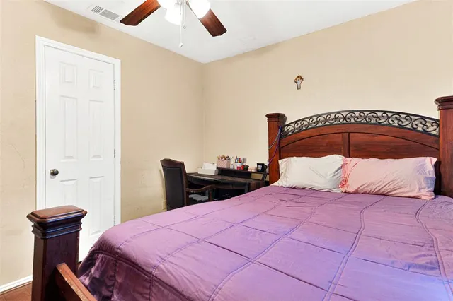 a bedroom with a bed and a chair