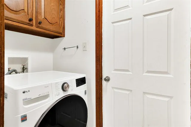 a view of washer and dryer with kitchen in the background