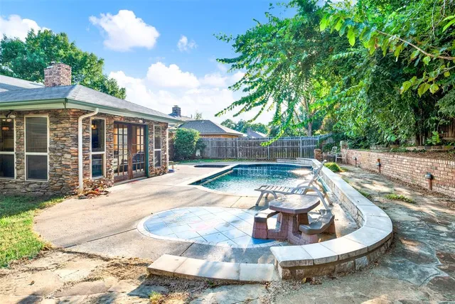 a view of a house with backyard outdoor seating area