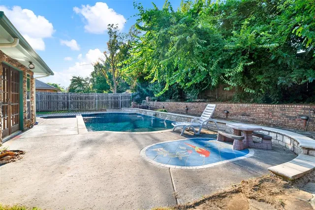 a view of a backyard with swimming pool