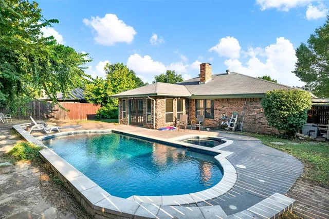 a view of a house with swimming pool and sitting area