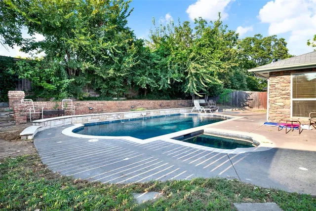 a view of a swimming pool with a patio