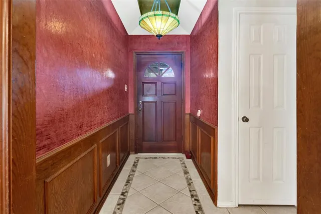 a view of a hallway with wooden door