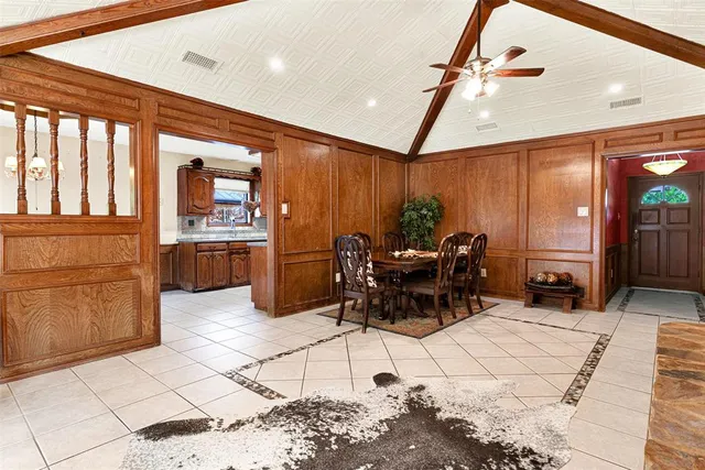 a work room with furniture a rug and a large window