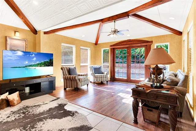 a living room with furniture and a floor to ceiling window