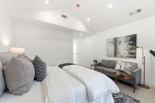 a bedroom with a bed and a couch