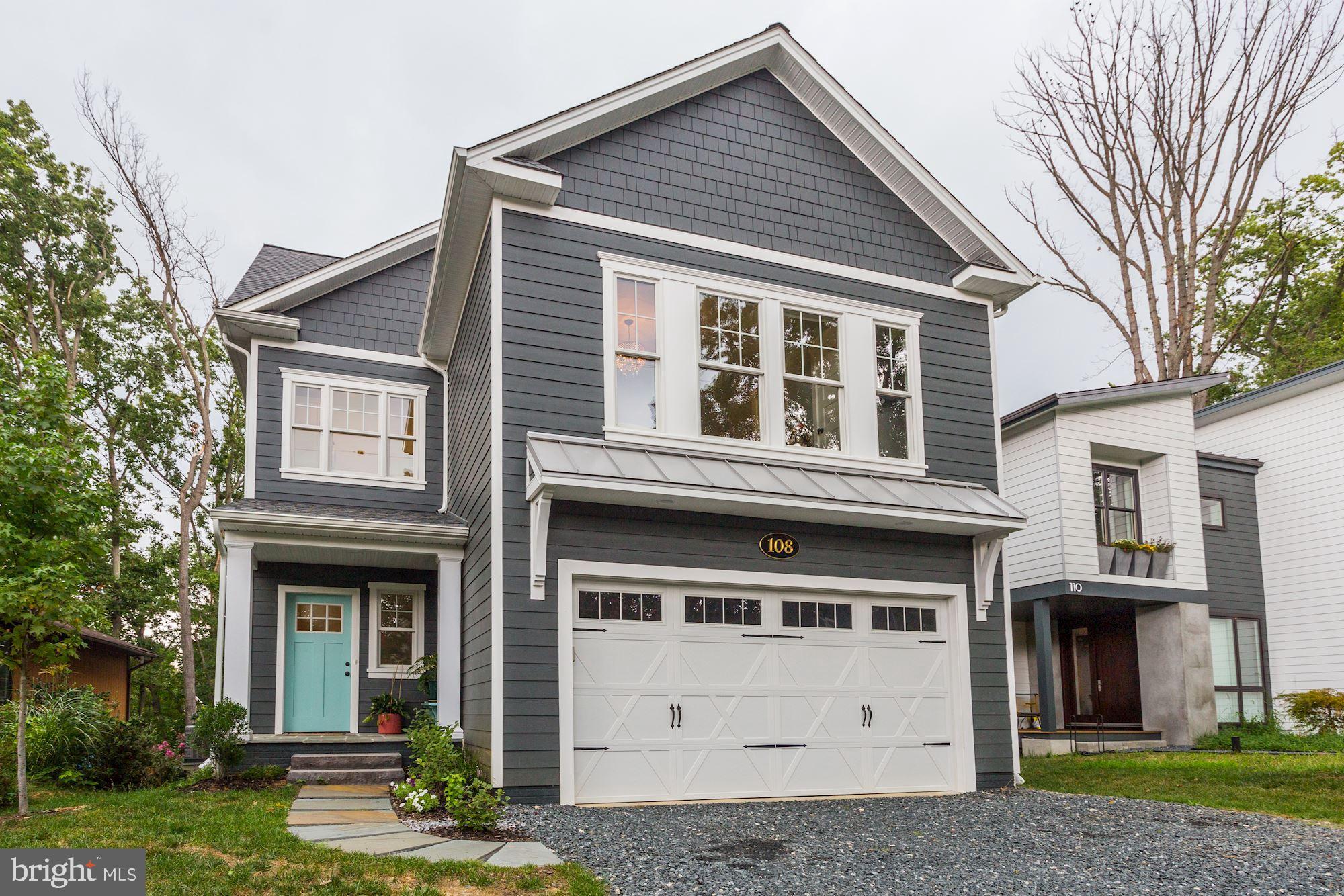 13374 Rousby Hall Road Lusby, MD 20657 - Photo 6 of 14 a front view of a house with a yard garage and outdoor seating