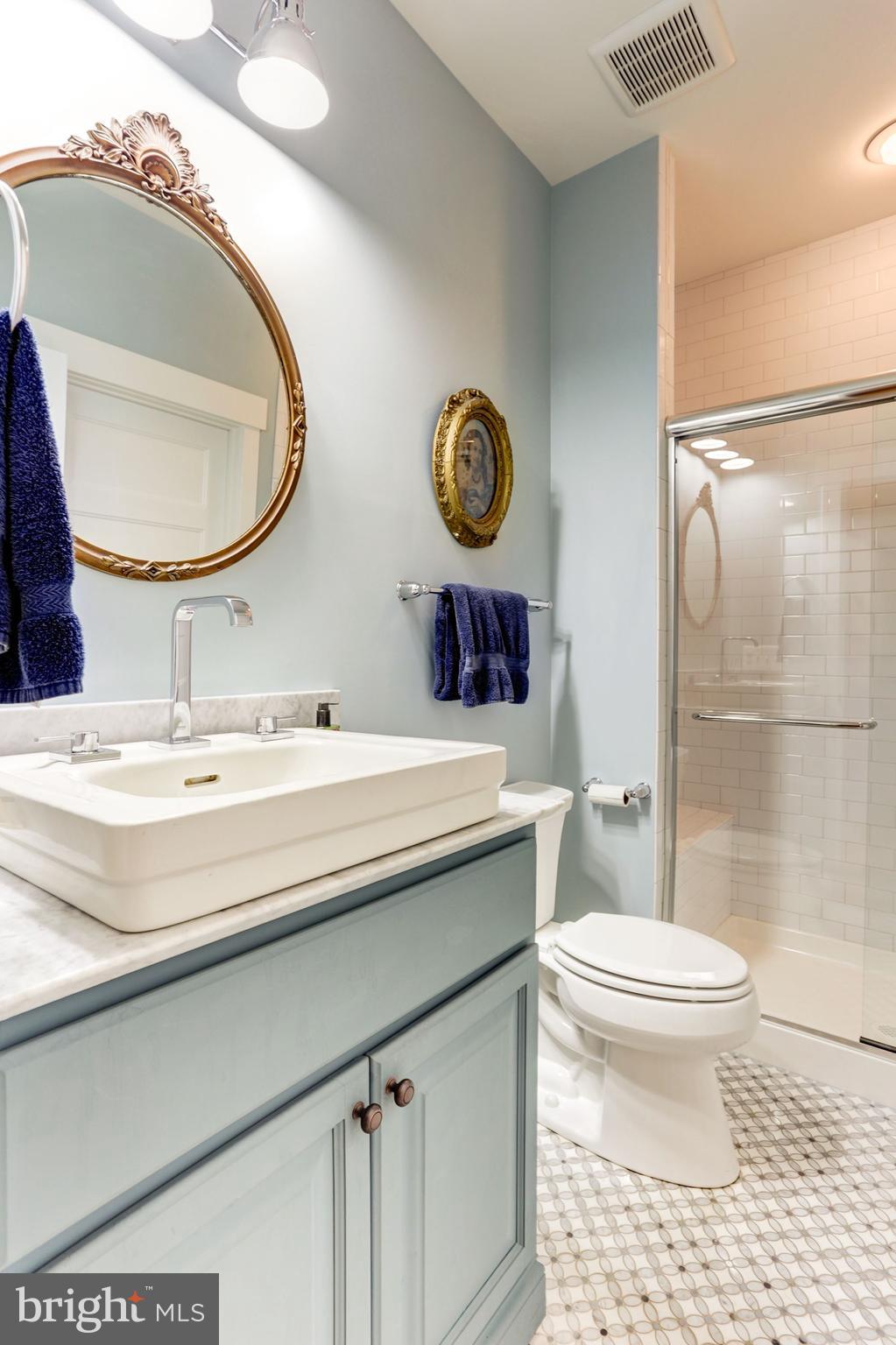13374 Rousby Hall Road Lusby, MD 20657 - Photo 10 of 14 a bathroom with a toilet a sink and a mirror